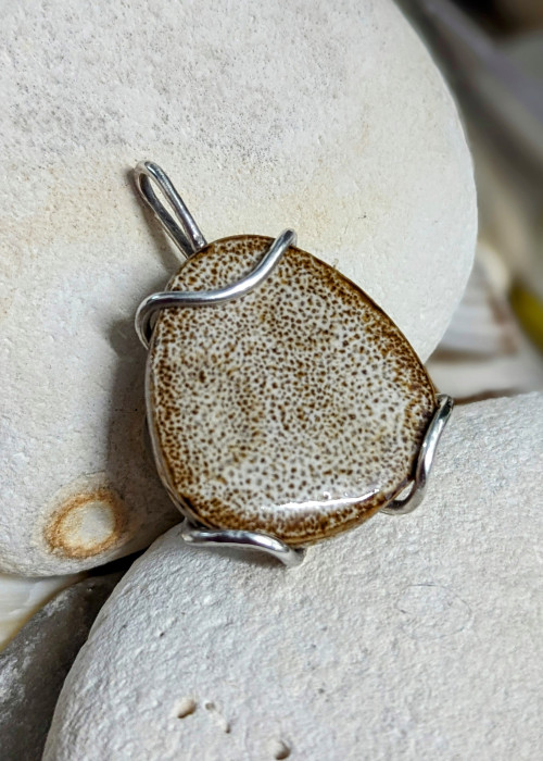 a stone pendant on rocks