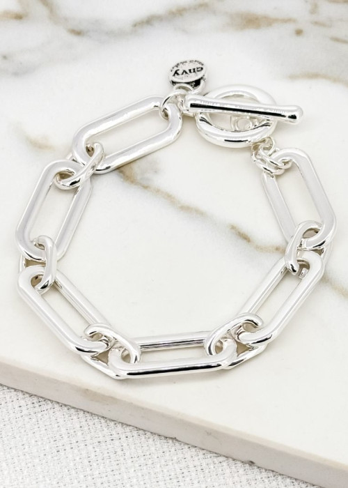 a silver chain bracelet on a marble surface
