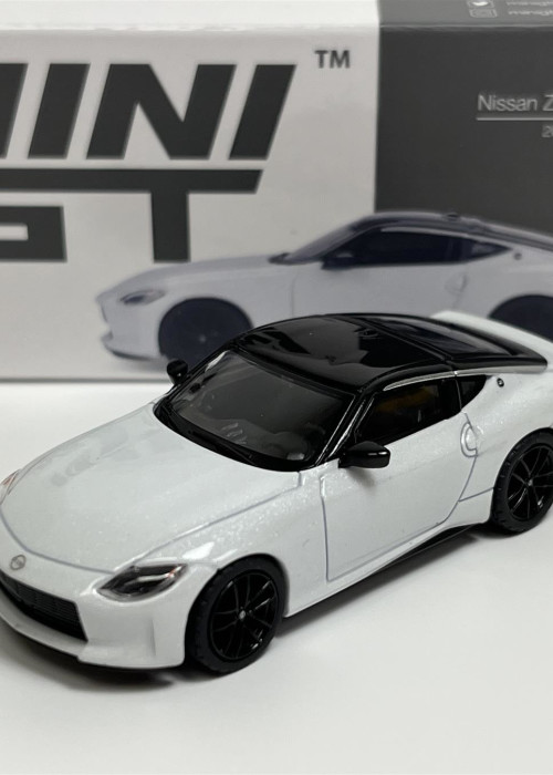 a white toy car with black roof