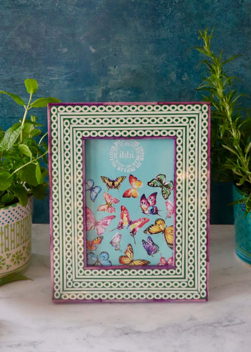 a picture frame with butterflies on it