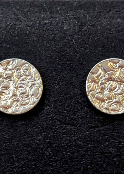 a pair of round silver earrings