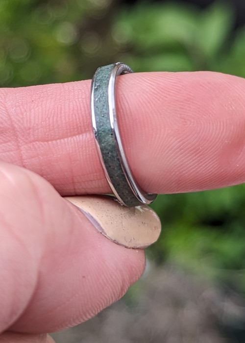 a person's finger with a ring on it