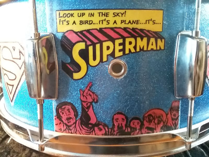 Pearl Export custom Assaulted Battery two color Superman themed graphics over a blue sparkle wrap