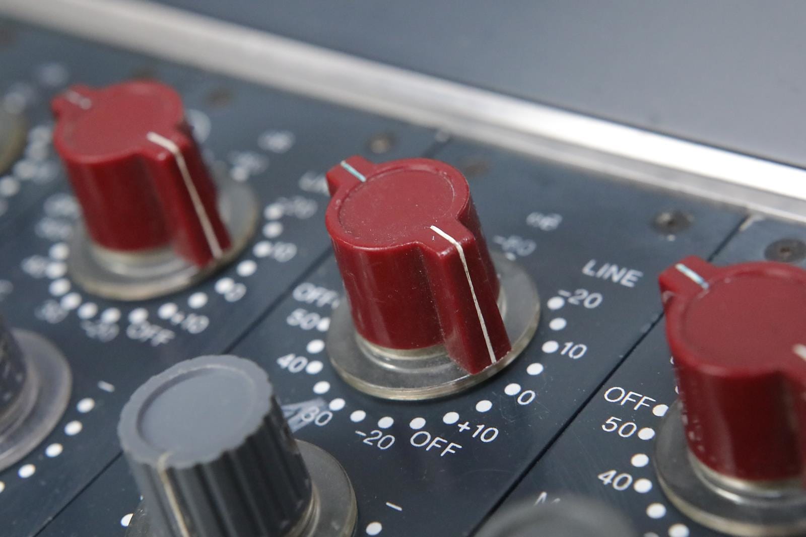 Close-up shot of a red Neve 8014 preamp knob.