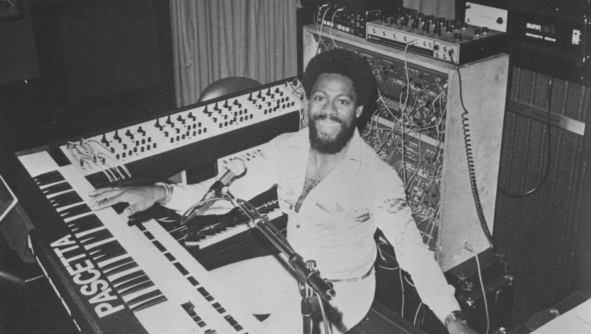 A photo of Don Lewis seated at his LEO synthesizer system..