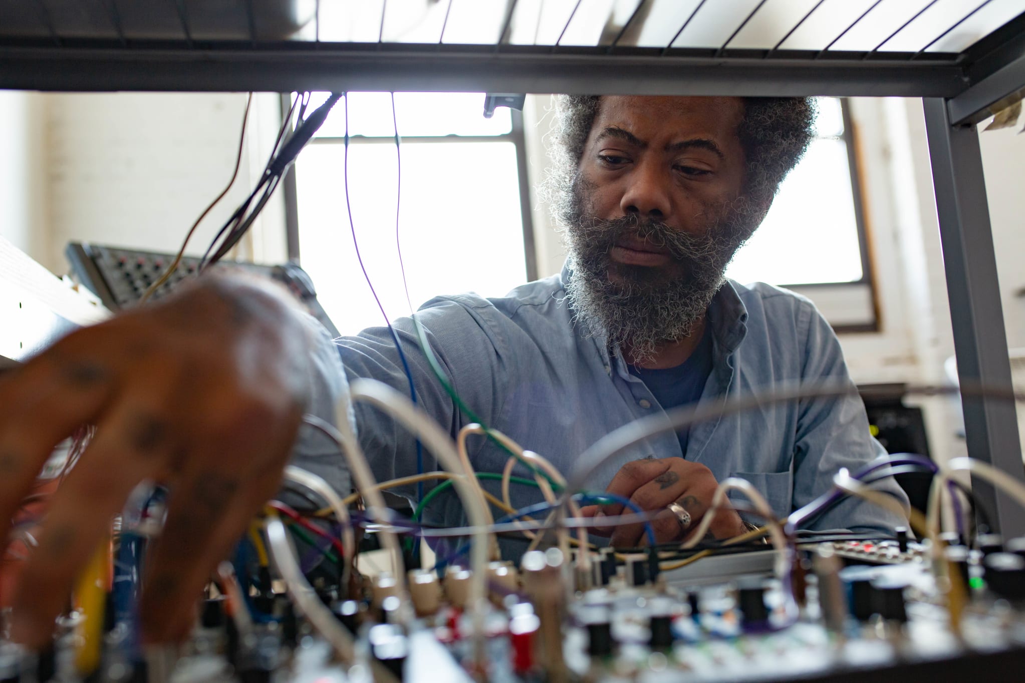 Robert Aiki Aubrey Lowe at a modular synth.