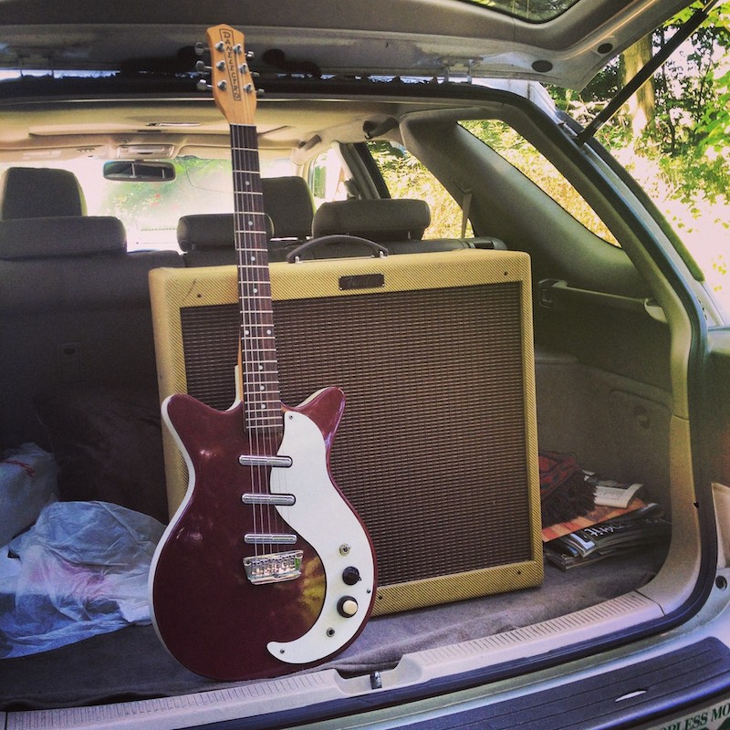 Danelectro DC-3 and Fender amp in the trunk of a car.