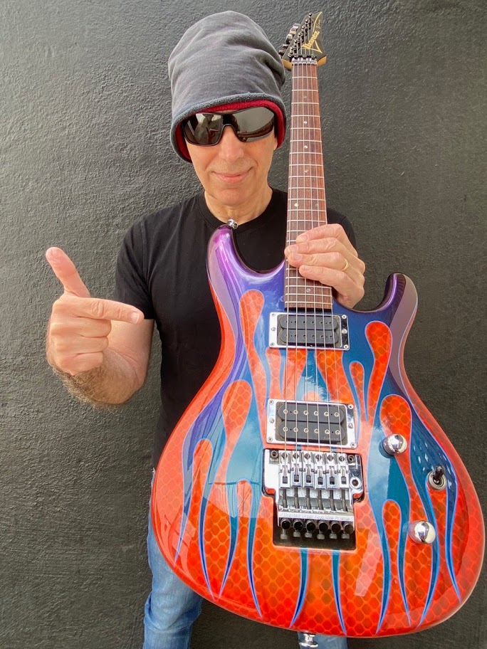 Joe Satriani with his signed Flame JS Signature