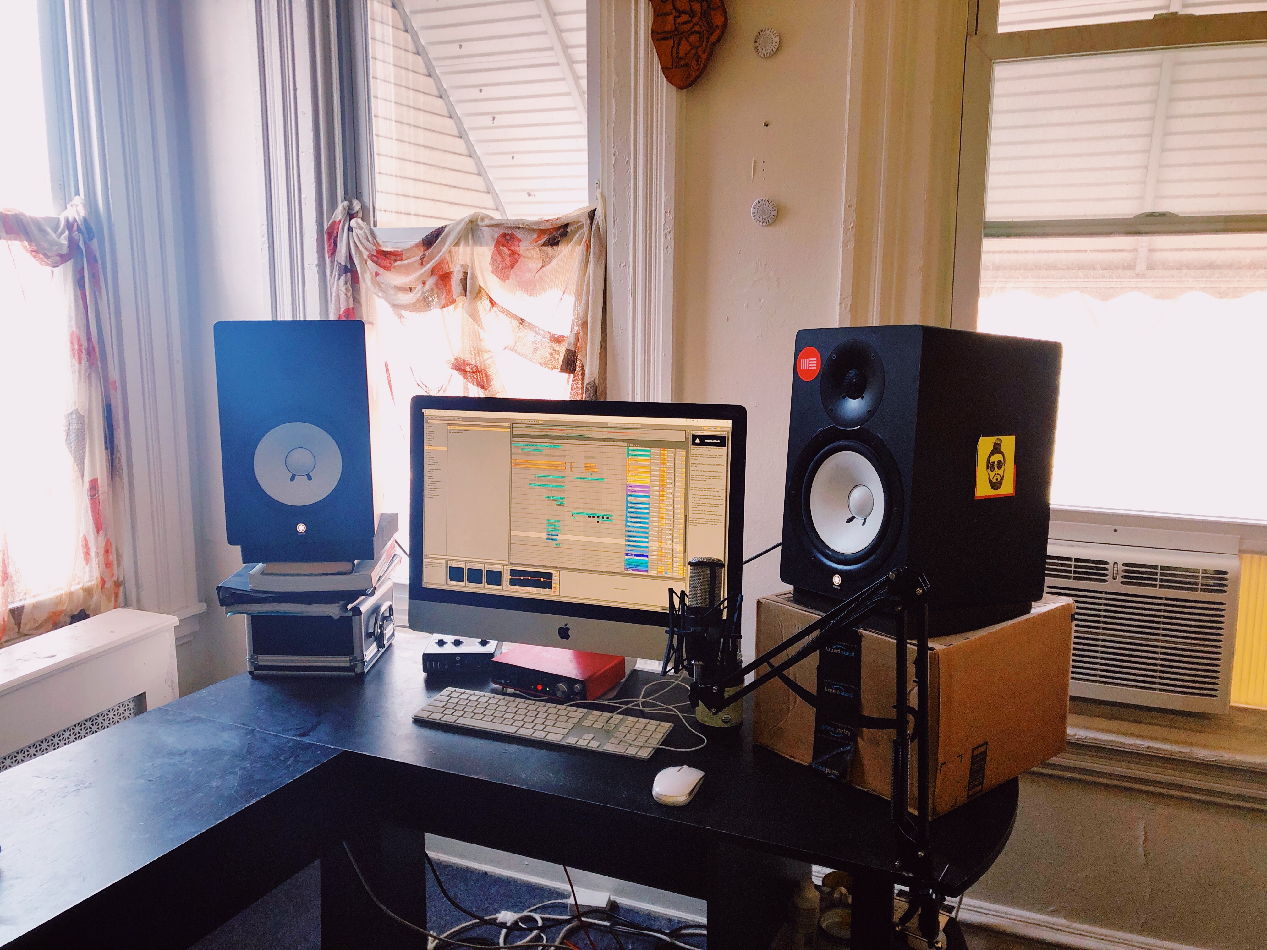 The producer's setup at home, a computer running Ableton Live and Yamaha monitors