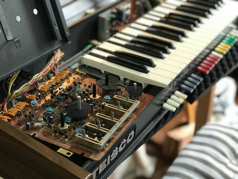 circuit board next to keyboard synth