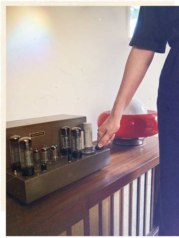 Alana turns a knob on the Marantz Model 8 amplifier.