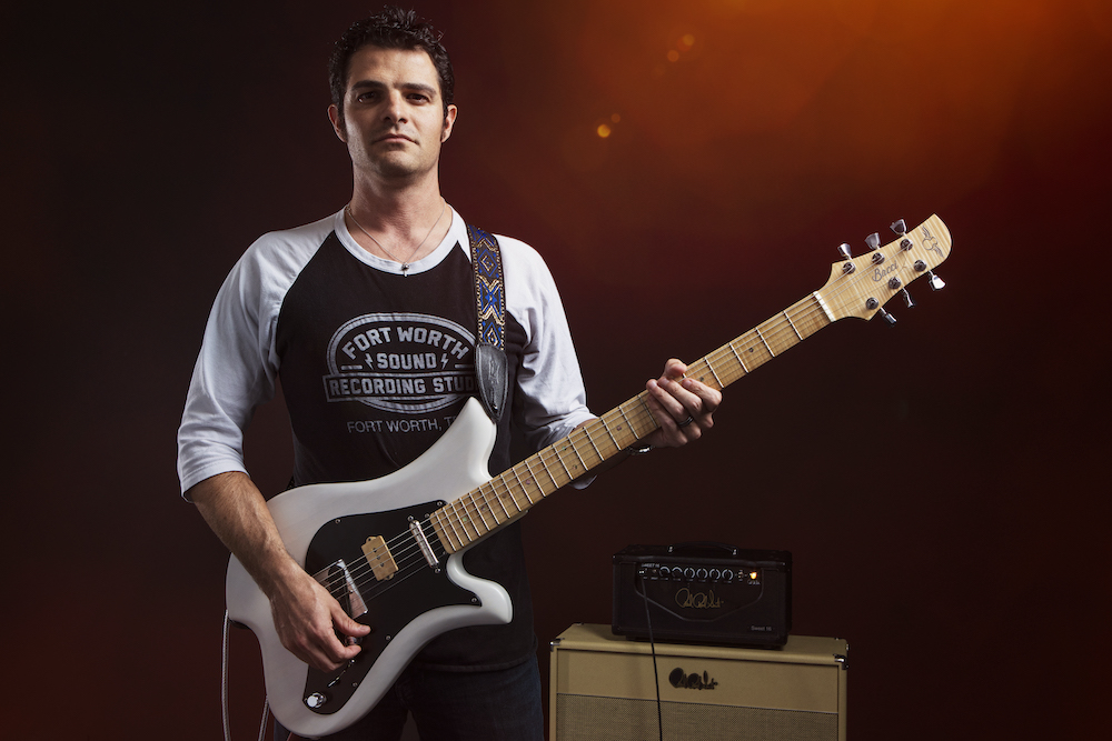 mark lettieri holding a guitar