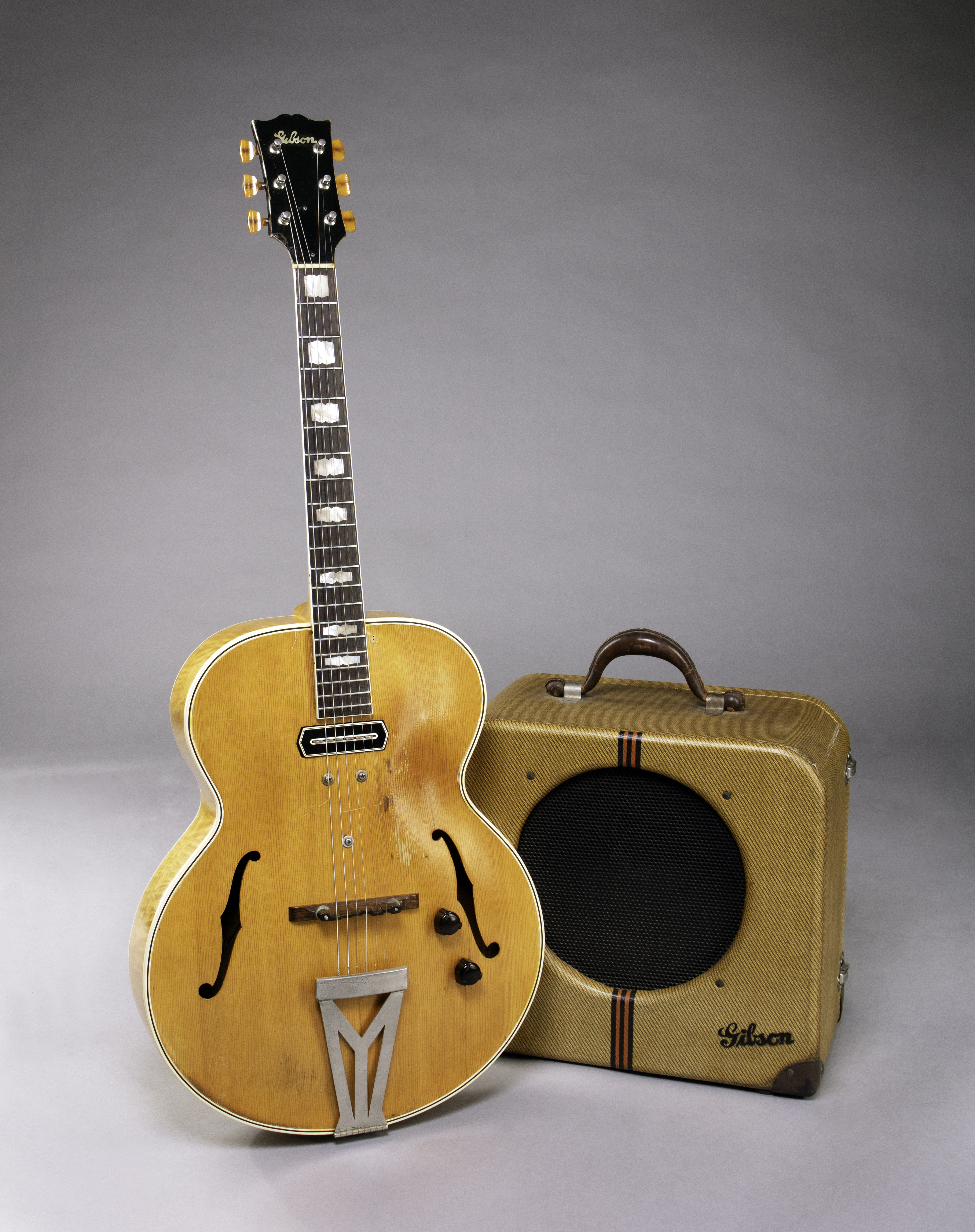 gibson es-250 next to an amp