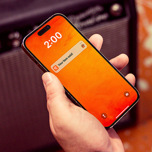 A phone screen displays a push notification that says Your item has sold