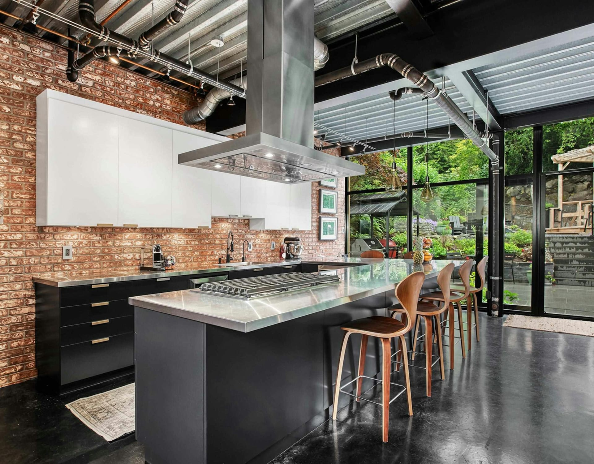A modern kitchen with a brick backsplash.
