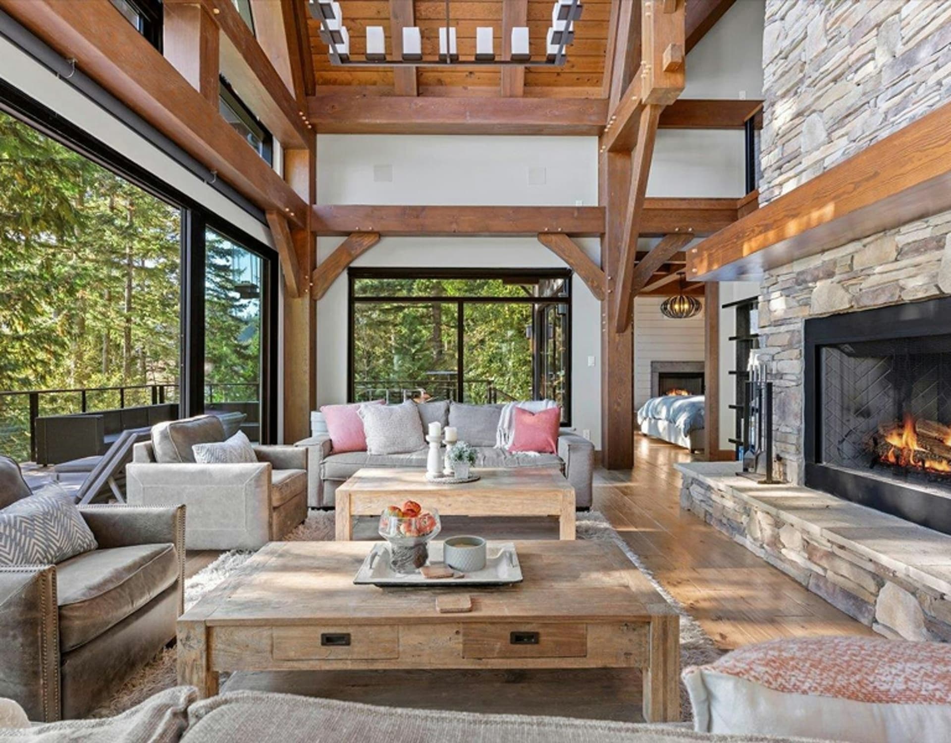 A living room overlooking a lush green landscape in the background.