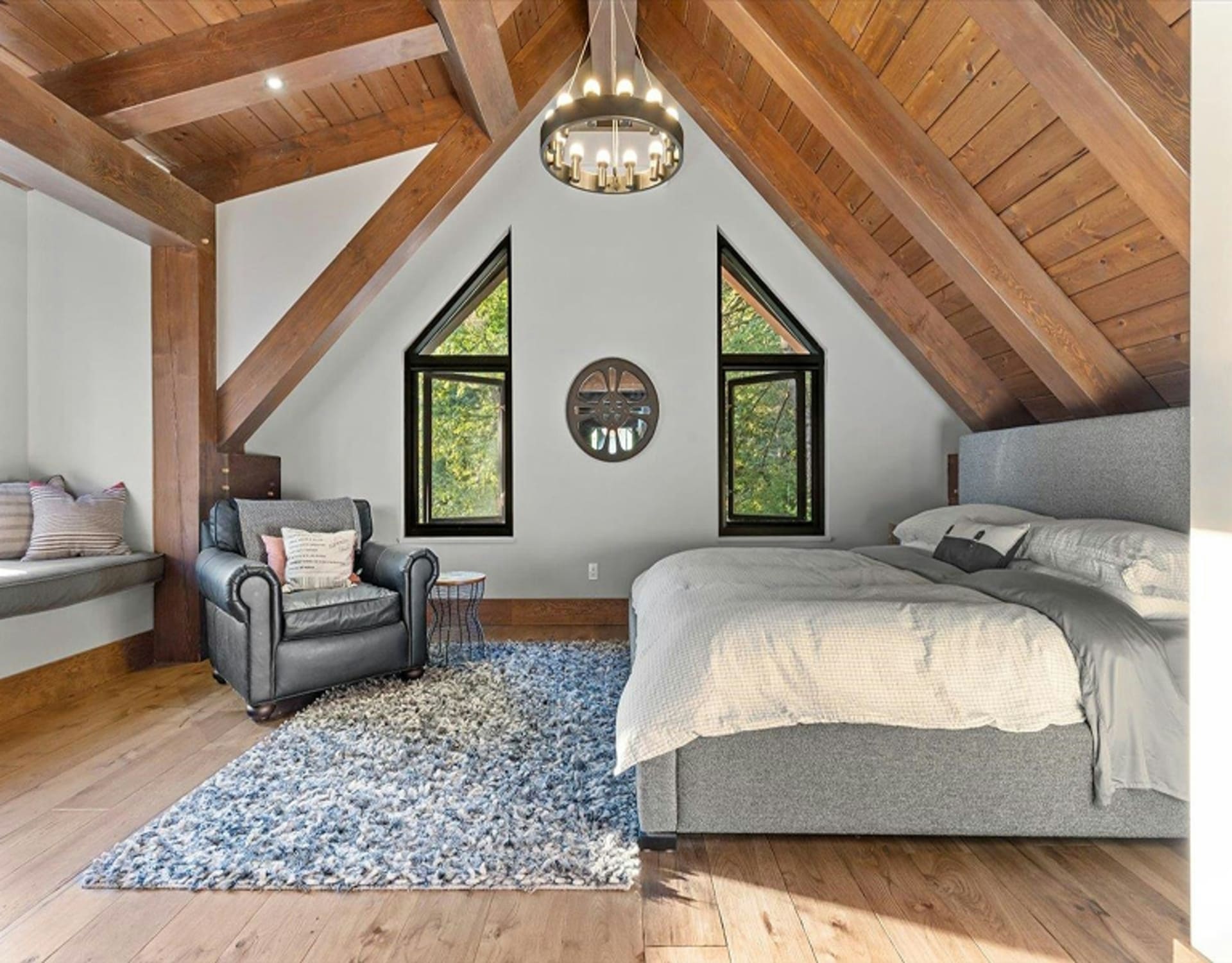 A bedroom with exposed wooden beams.