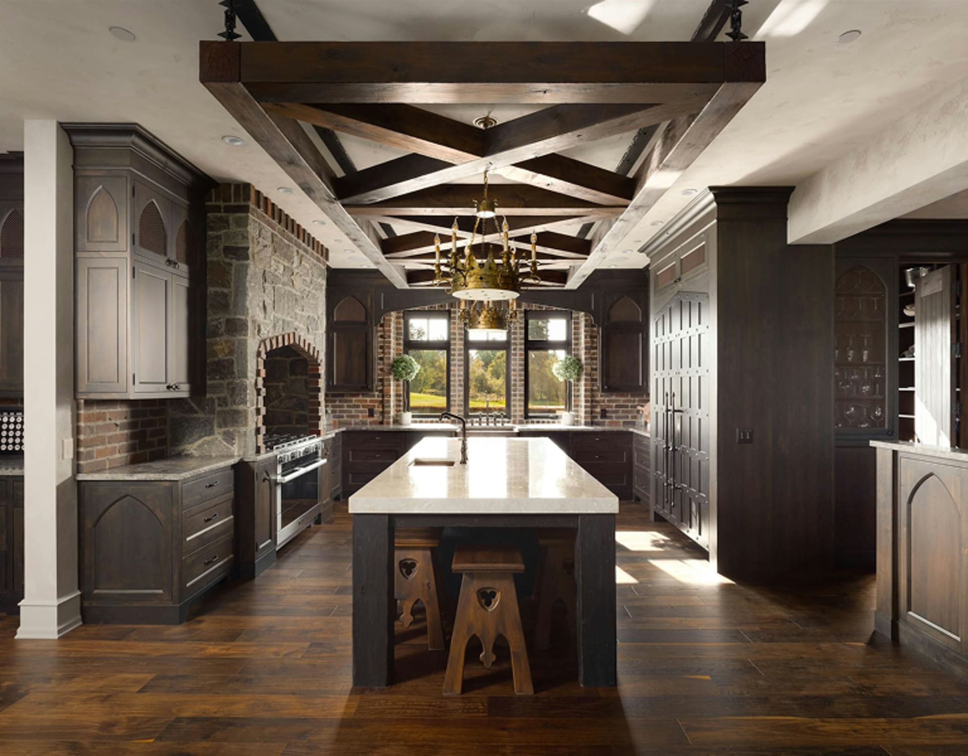 A spacious and elegantly designed kitchen with dark wood cabinetry, a large central island, and a striking overhead beam structure.