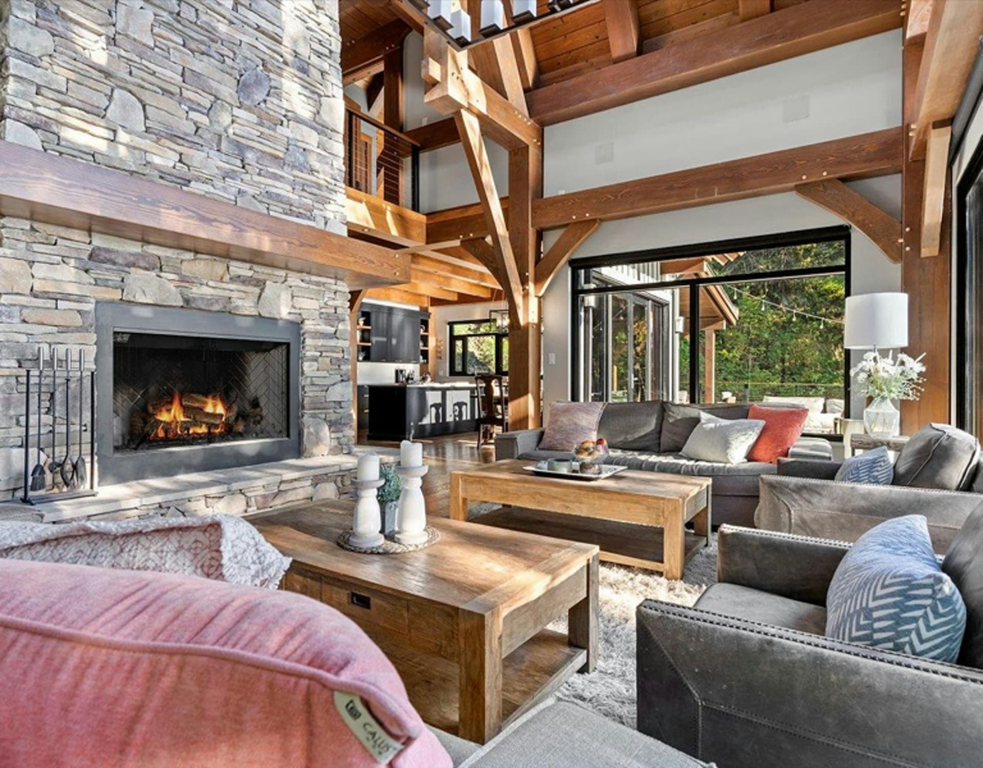 A cozy living room with a stone fireplace.
