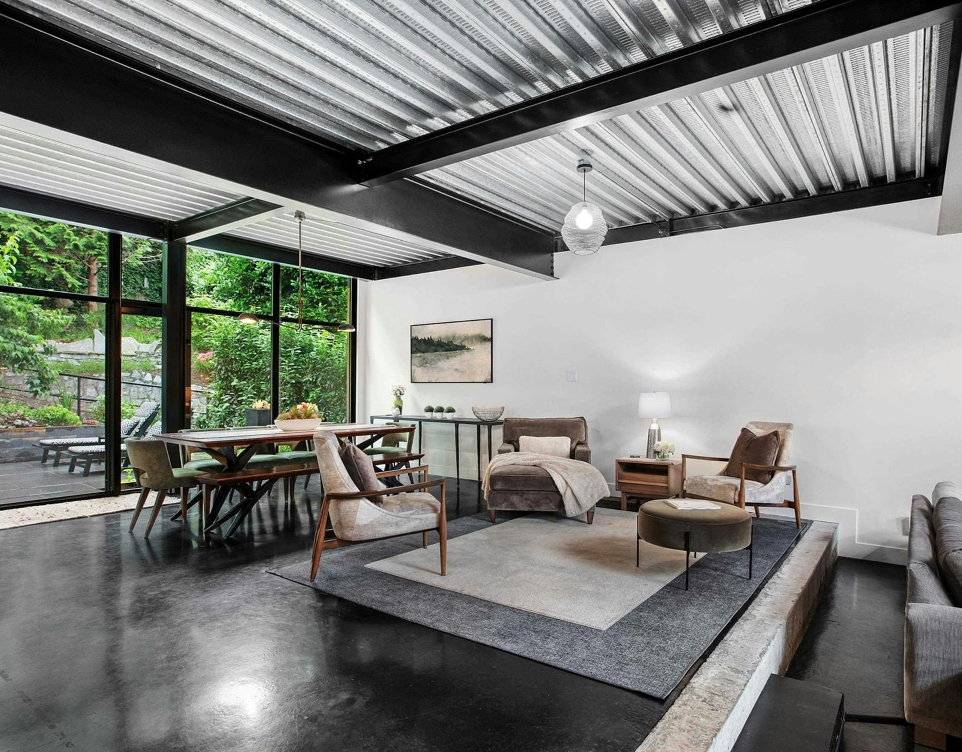 A modern living and dining area with a dark polished floor.
