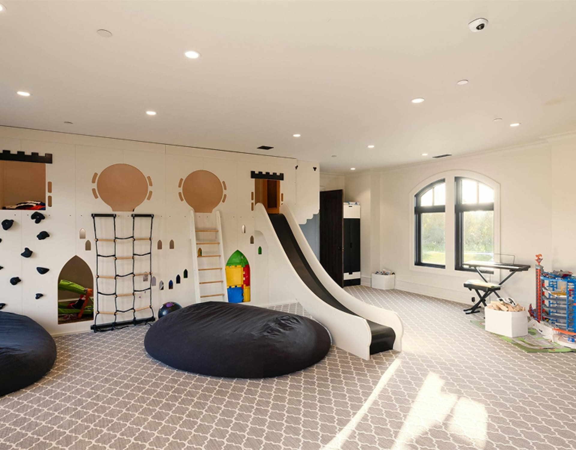 A spacious indoor play area with various colourful elements.