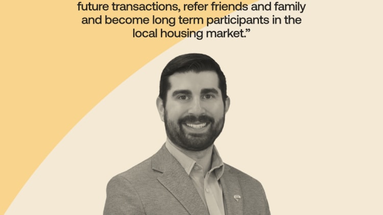 The image shows a smiling man in a gray suit standing against a yellow background, with a quote about newcomer clients in the local housing market.
