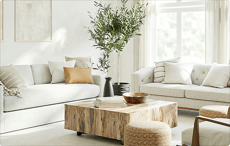 A mock-up interior from the BC Home and Garden show, with pale sofas surrounding a wood-block coffee table in a pale room.