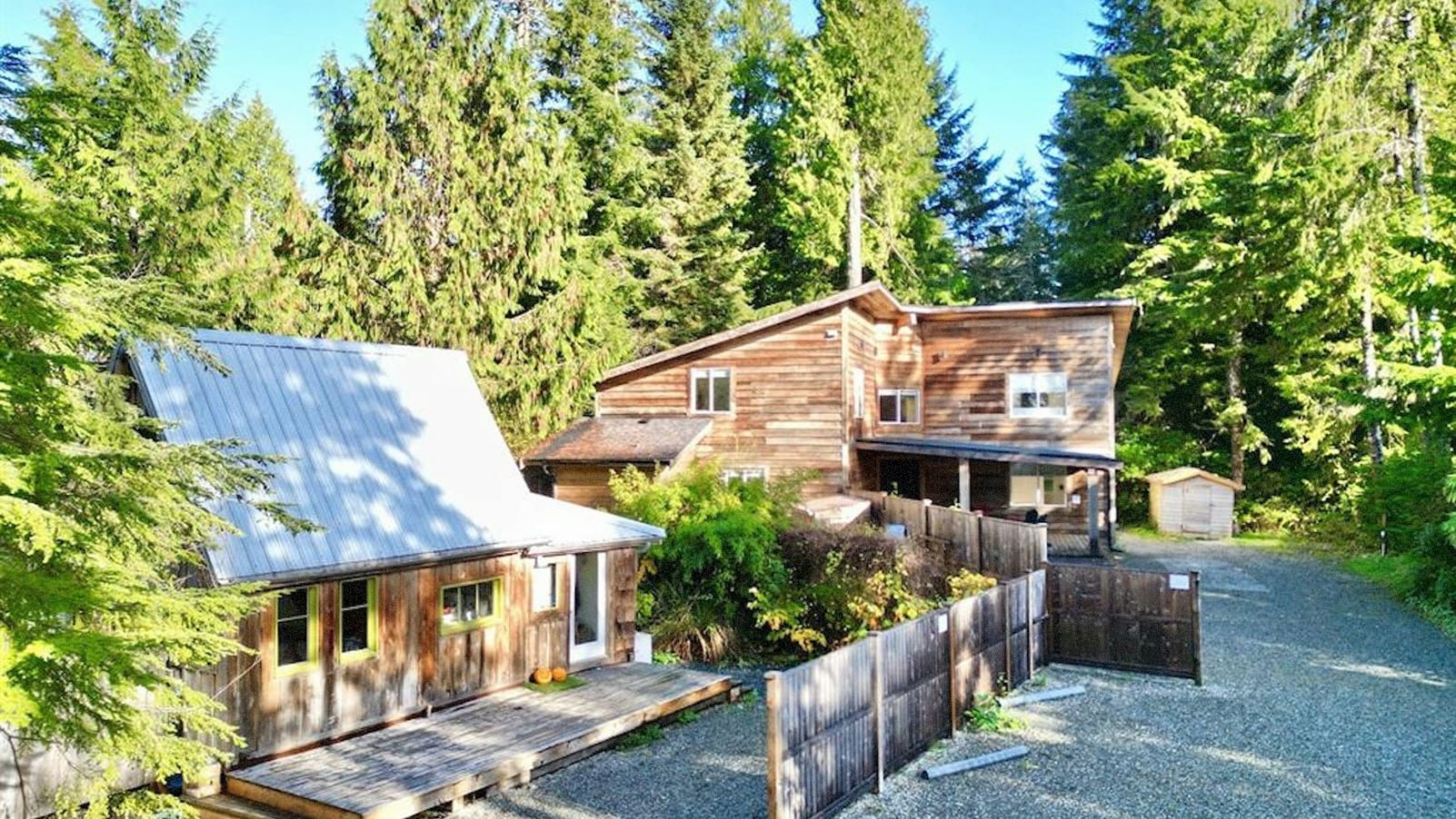 Tofino detached home with wood siding in the forest.