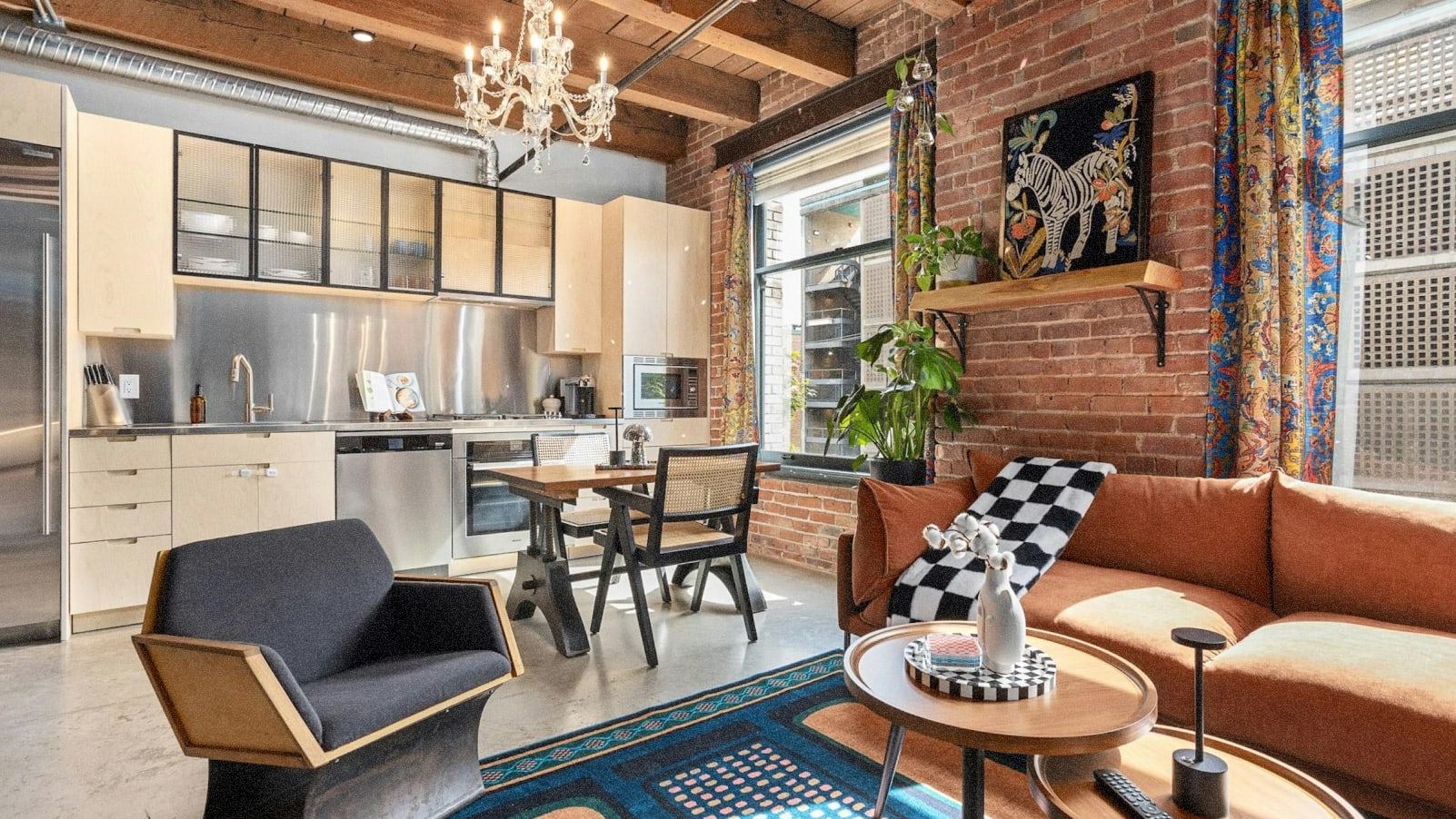Converted warehouse condo interior with exposed wood and contemporary furniture.