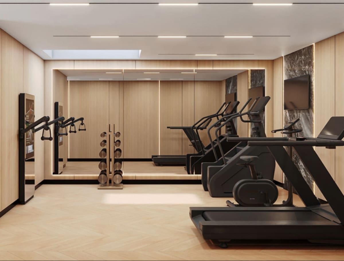 A modern, well-equipped home gym with various exercise equipment, including treadmills, weight machines, and other fitness apparatus, set against a minimalist, wood-paneled interior design.