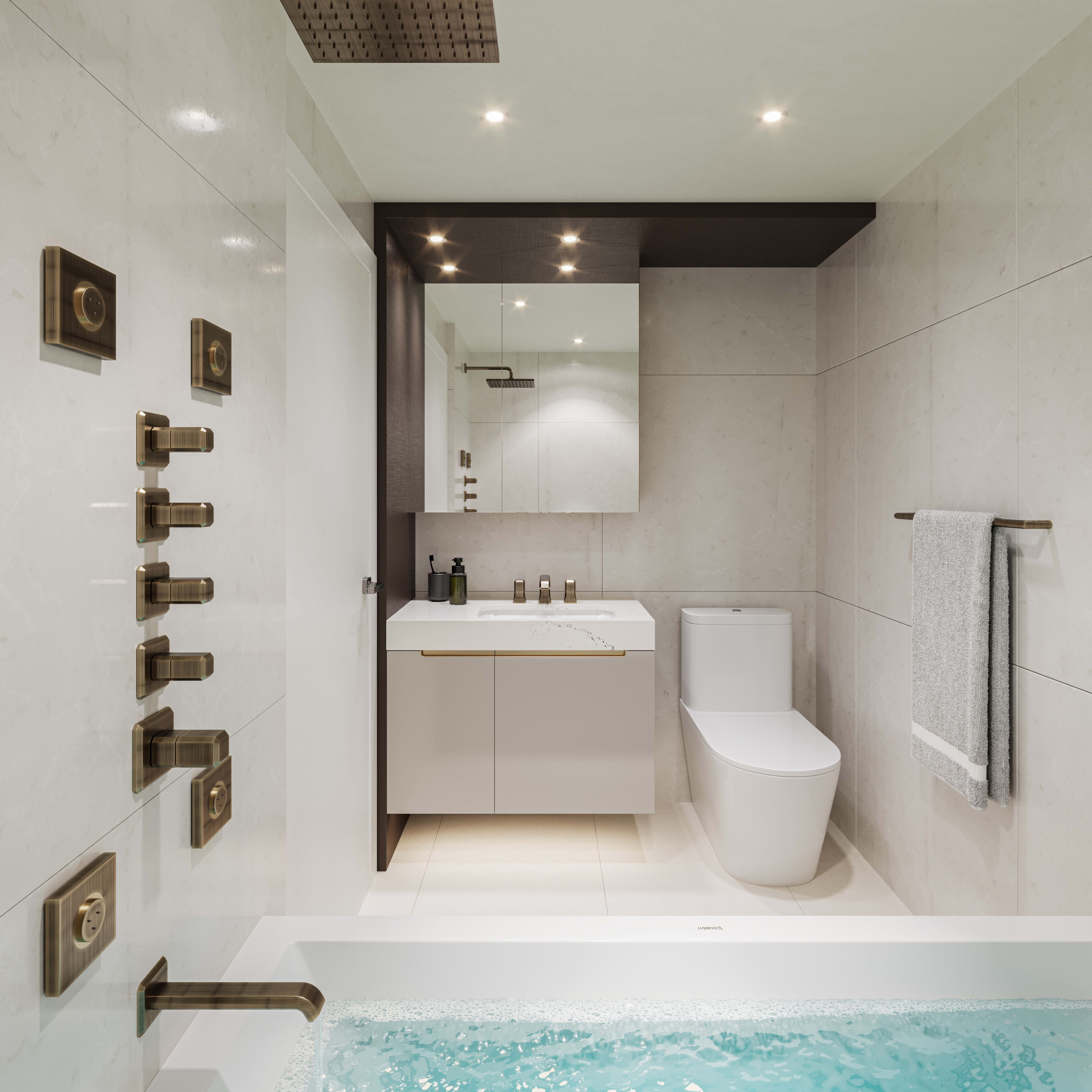 A modern and minimalist bathroom with a white vanity, toilet, and a sunken bathtub filled with water, surrounded by sleek tile walls and recessed lighting.