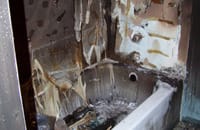 Melted bathtub surround after a house fire
