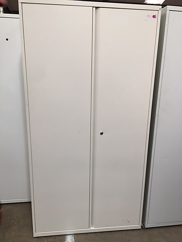 Tall white metal storage cabinet