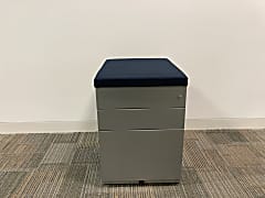 Grey metal 3 drawer pedestal with blue cushion seat top