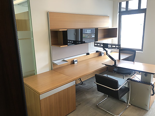 brown wooden desk with ped and shelving