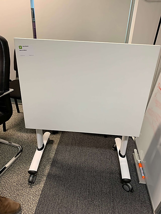 Small folding white table on wheels