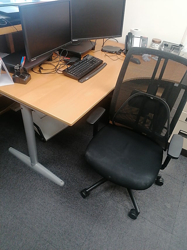 brown wooden computer desk with black rolling chair