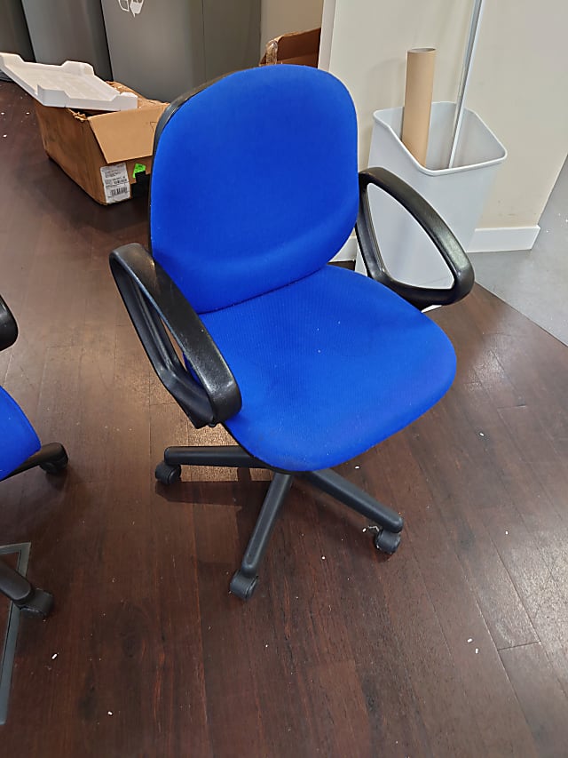 Low back blue operator chair with O arms