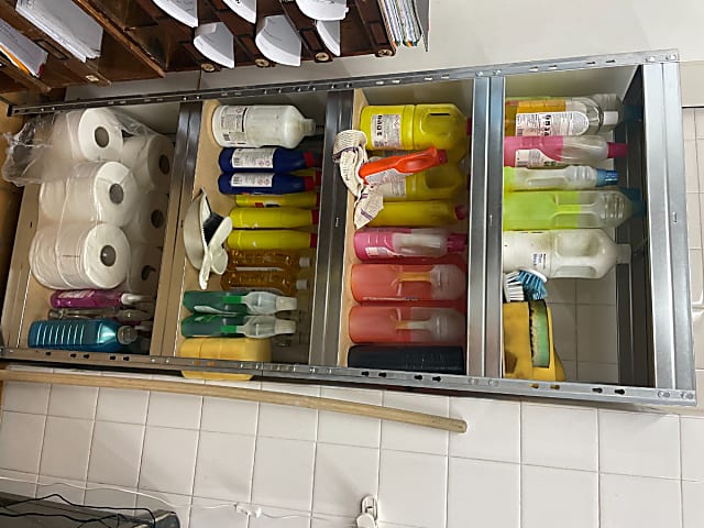 Dougs office - steel shelves with cleaning bottles