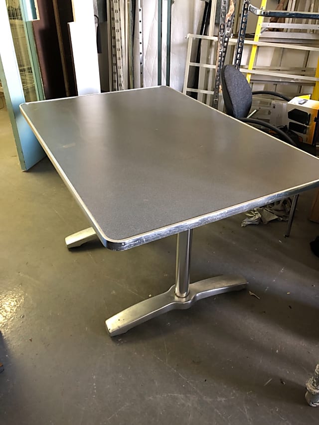 Grey table with metal trim and frame