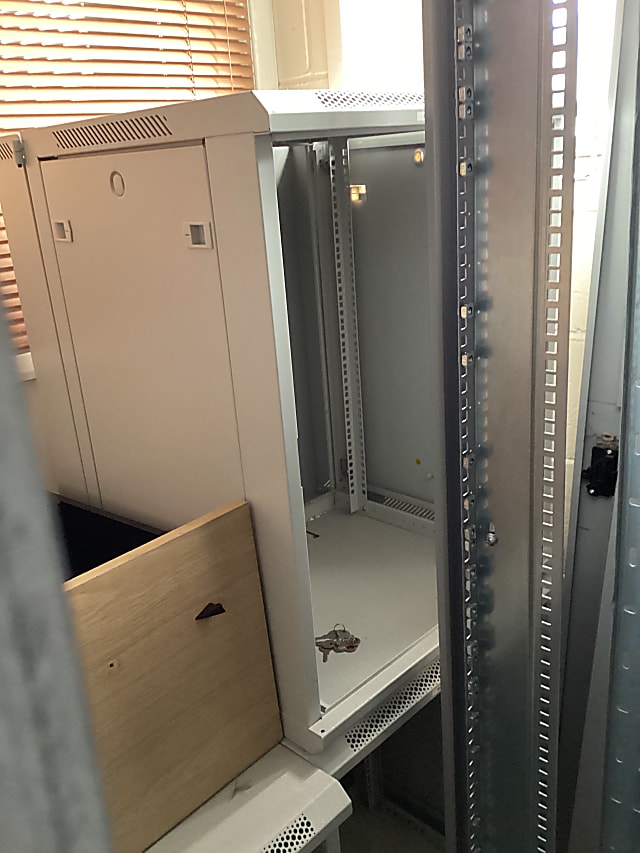 Small grey empty server cabinet