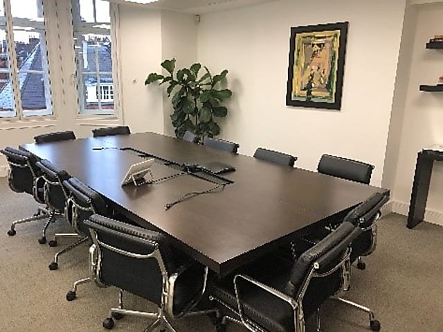 Dark brown boardroom table with in built holder for IT cabling