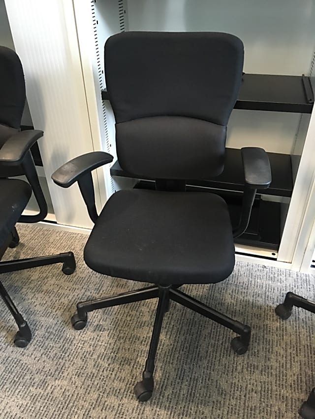 Black rolling operator chair