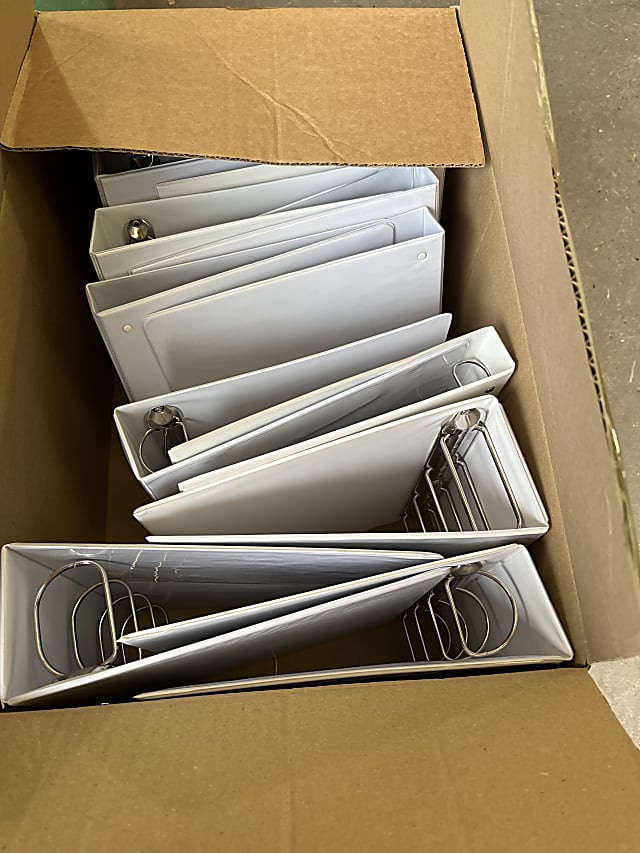 Box of used plastic binders wide