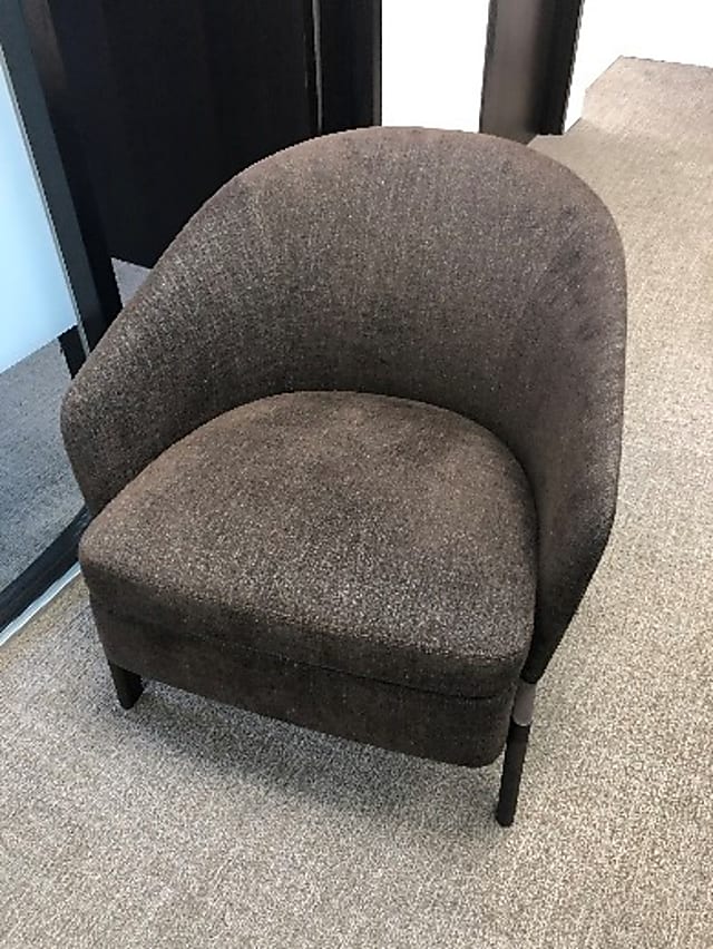 Brown and grey speckled fabric armchair