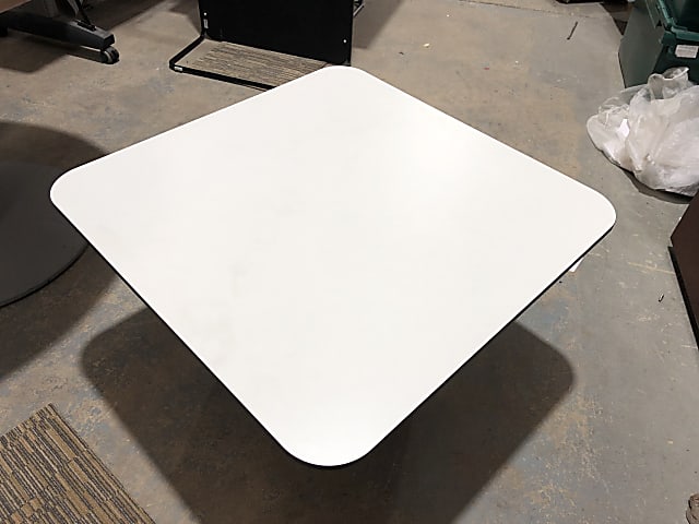 Small white square table with power sockets inside stand