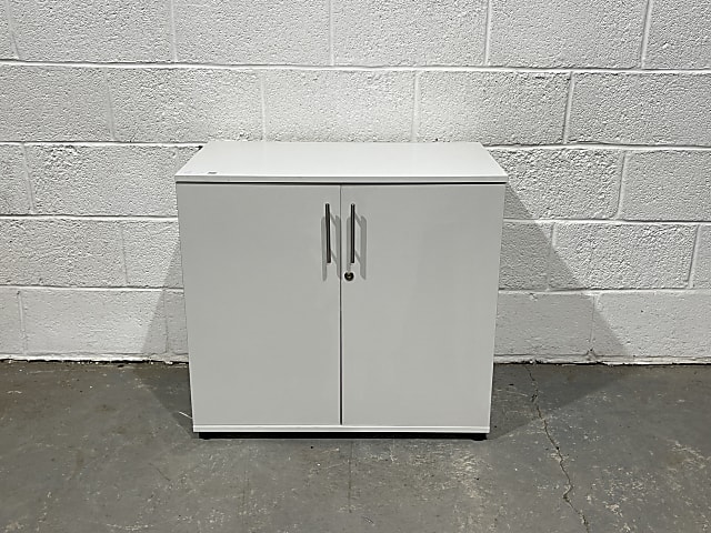 white wooden 2-door cabinet with keys and shelf