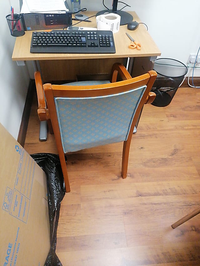 brown wooden desk with black rolling chair