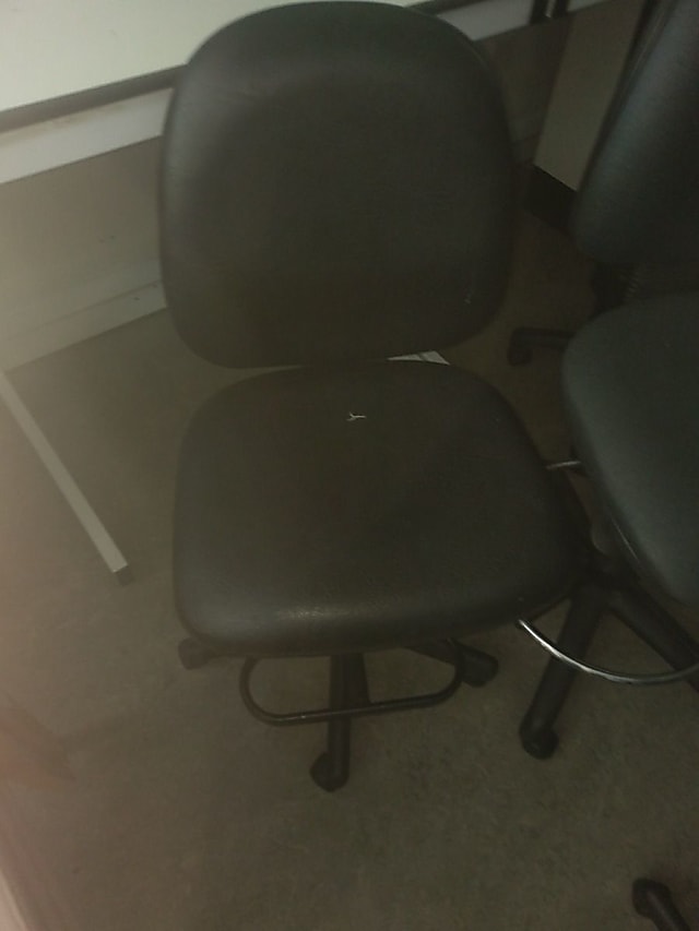 black rolling armless chair