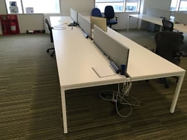 Bank of 6 white desks with dividers